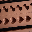 Load image into Gallery viewer, Silicone mold with bone and heart shapes branded 'EmeryPets x Crave Carnivore' on a dark surface.