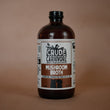 Load image into Gallery viewer, Bottle of Crude Carnivore Mushroom Broth on a brown background