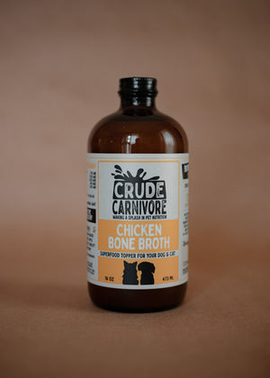 Bottle of Crude Carnivore Chicken Bone Broth on a brown background