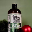Load image into Gallery viewer, Bottle of Crude Carnivore duck bone broth with a red ornament on a green background
