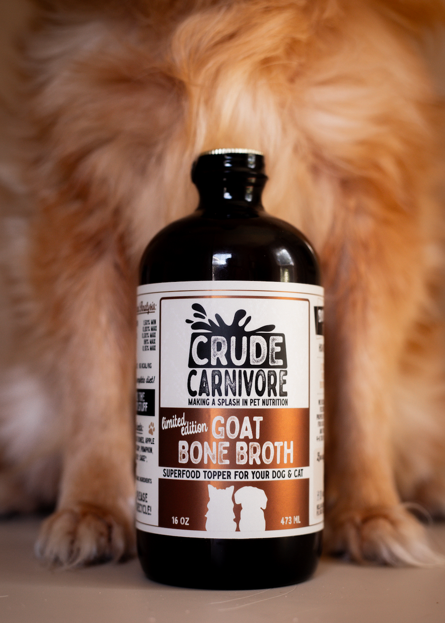 Bottle of Crude Carnivore Goat Bone Broth with a dog in the background