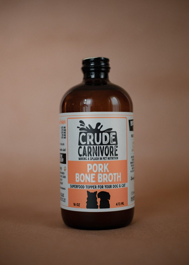 Bottle of Crude Carnivore Pork Bone Broth on a brown background