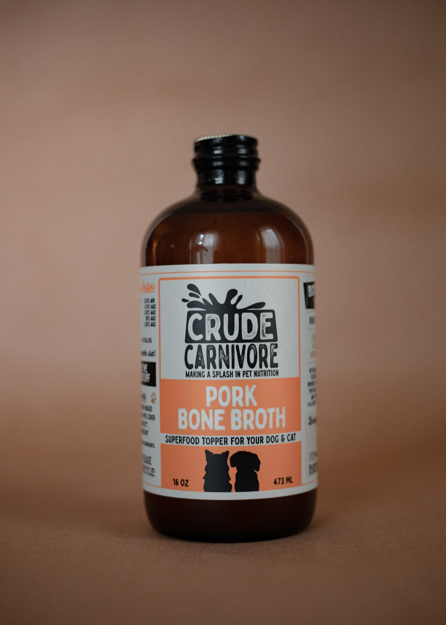 Bottle of Crude Carnivore Pork Bone Broth on a brown background